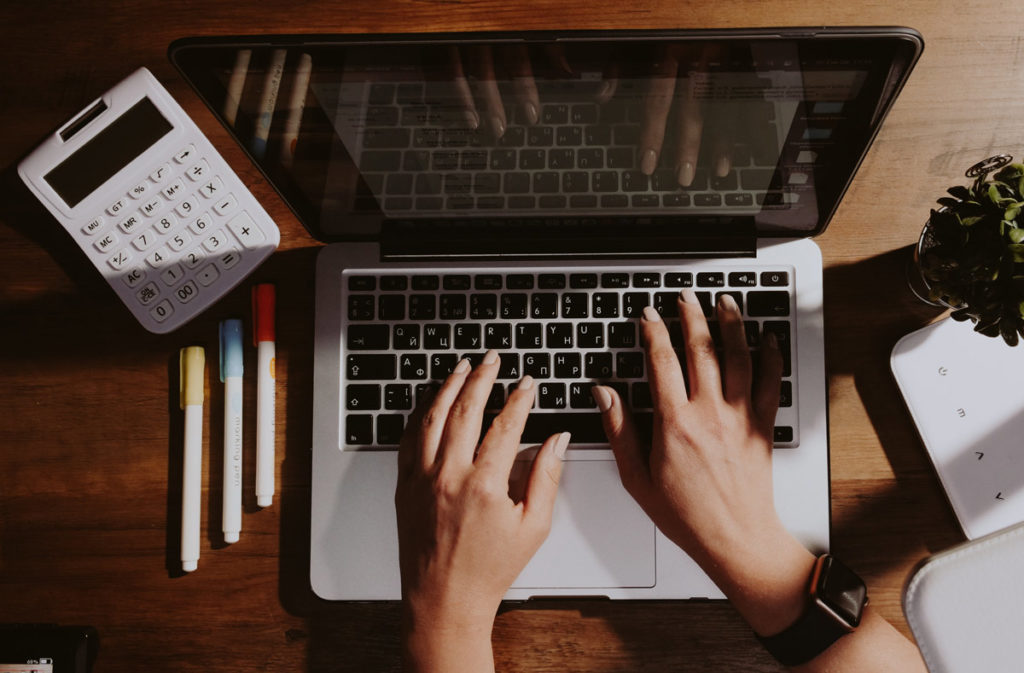 hands on laptop keyboard