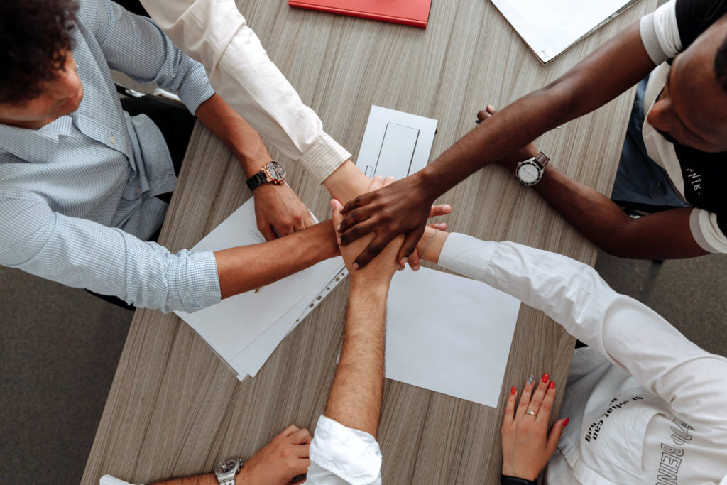 diverse group with hands on top of each other